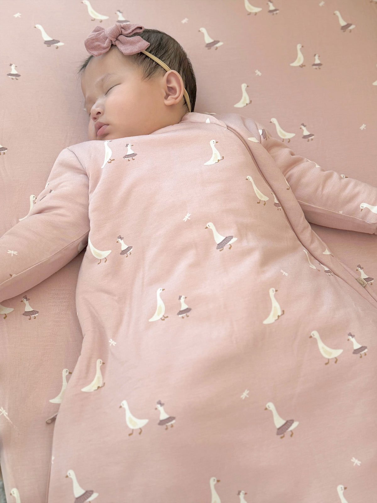 Blush pink long-sleeve sleep sack with white swan print