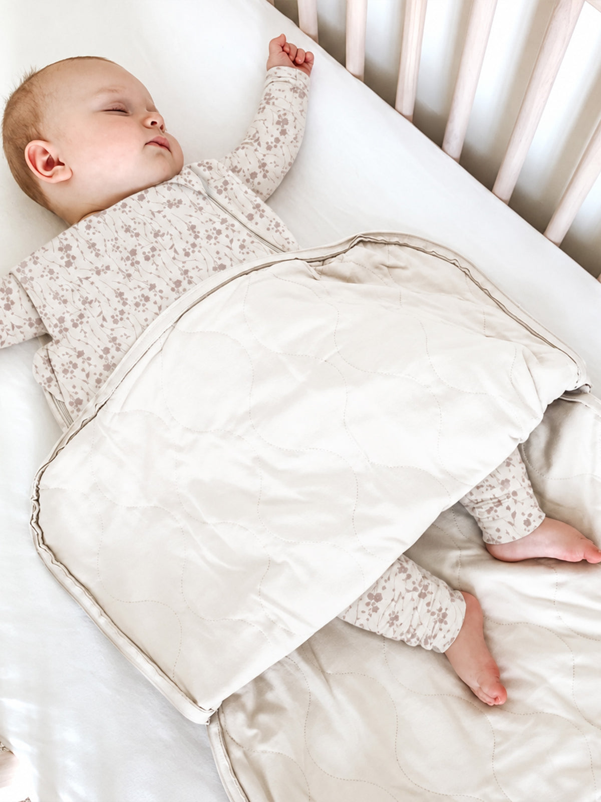 Beige floral sleep sack with zip opening, large folded shoulder panel