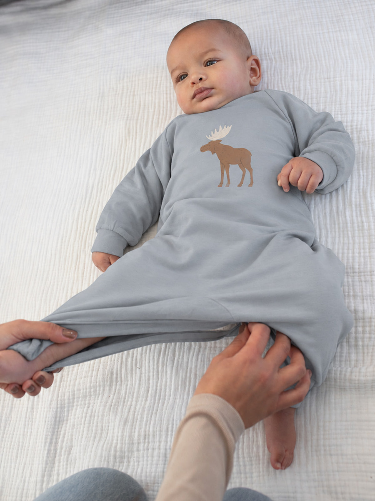 Light gray fleece jumpsuit with moose patch, long sleeves and snap legs
