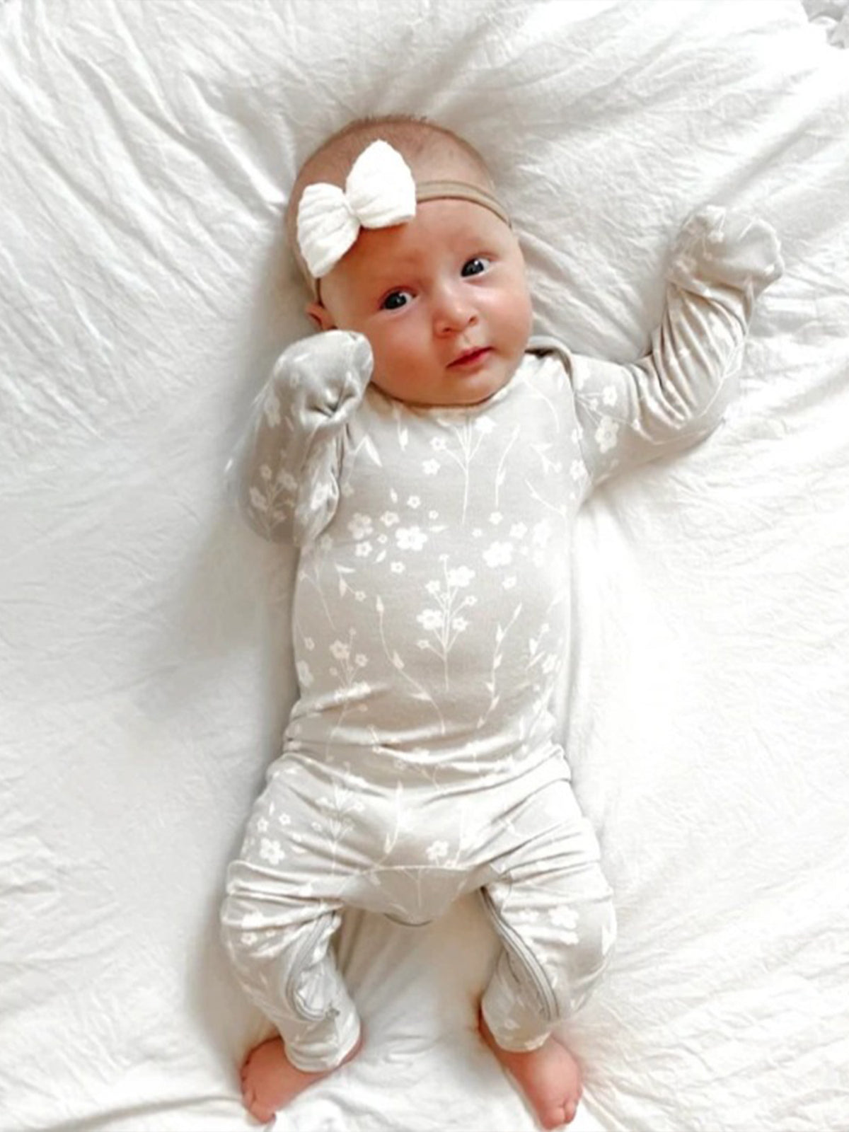 Light convertible pajama with white floral print, long sleeves, and gathered ankle cuffs