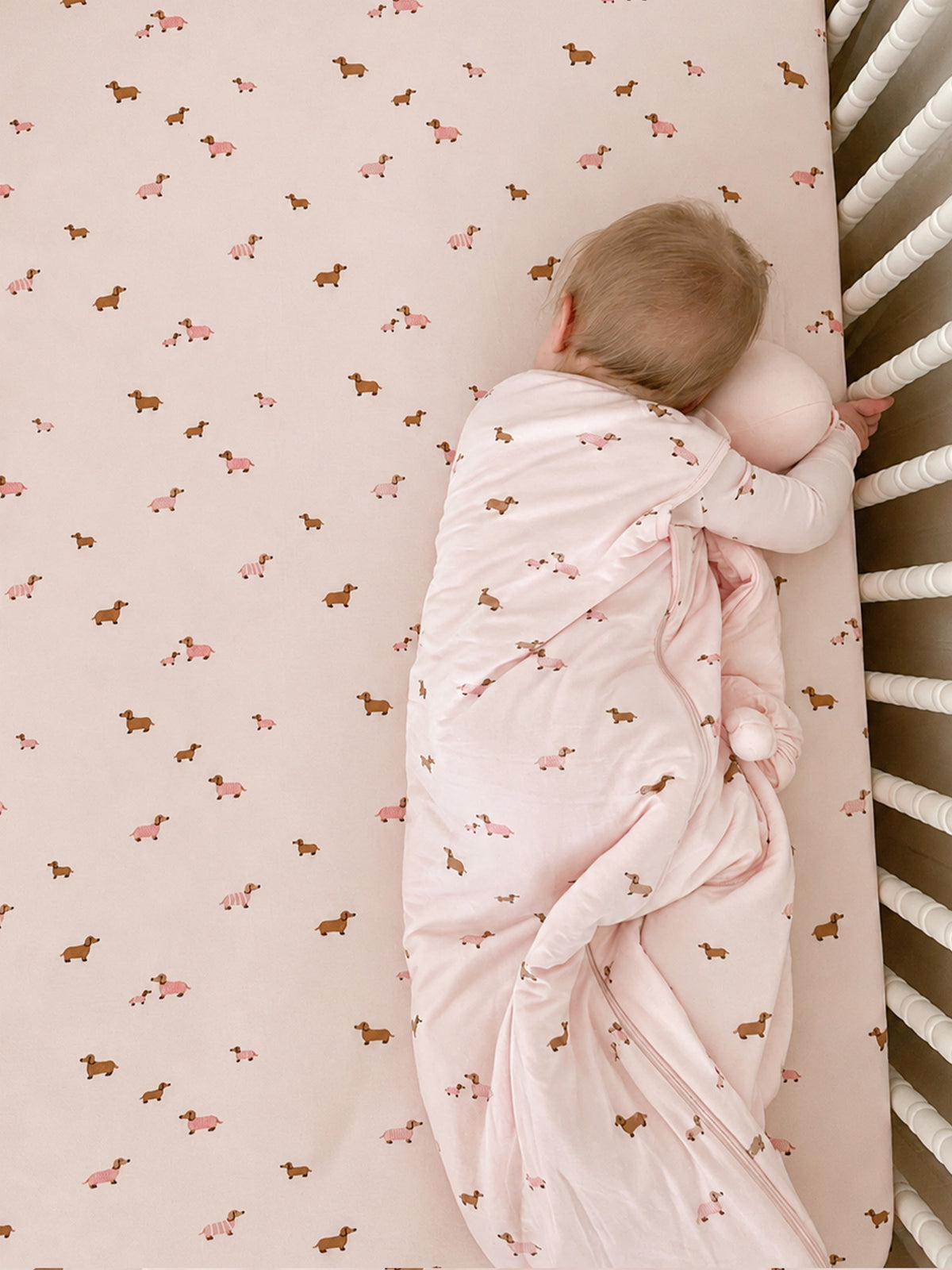 Pink dog-print sleep sack with long sleeves and open back for baby, footless