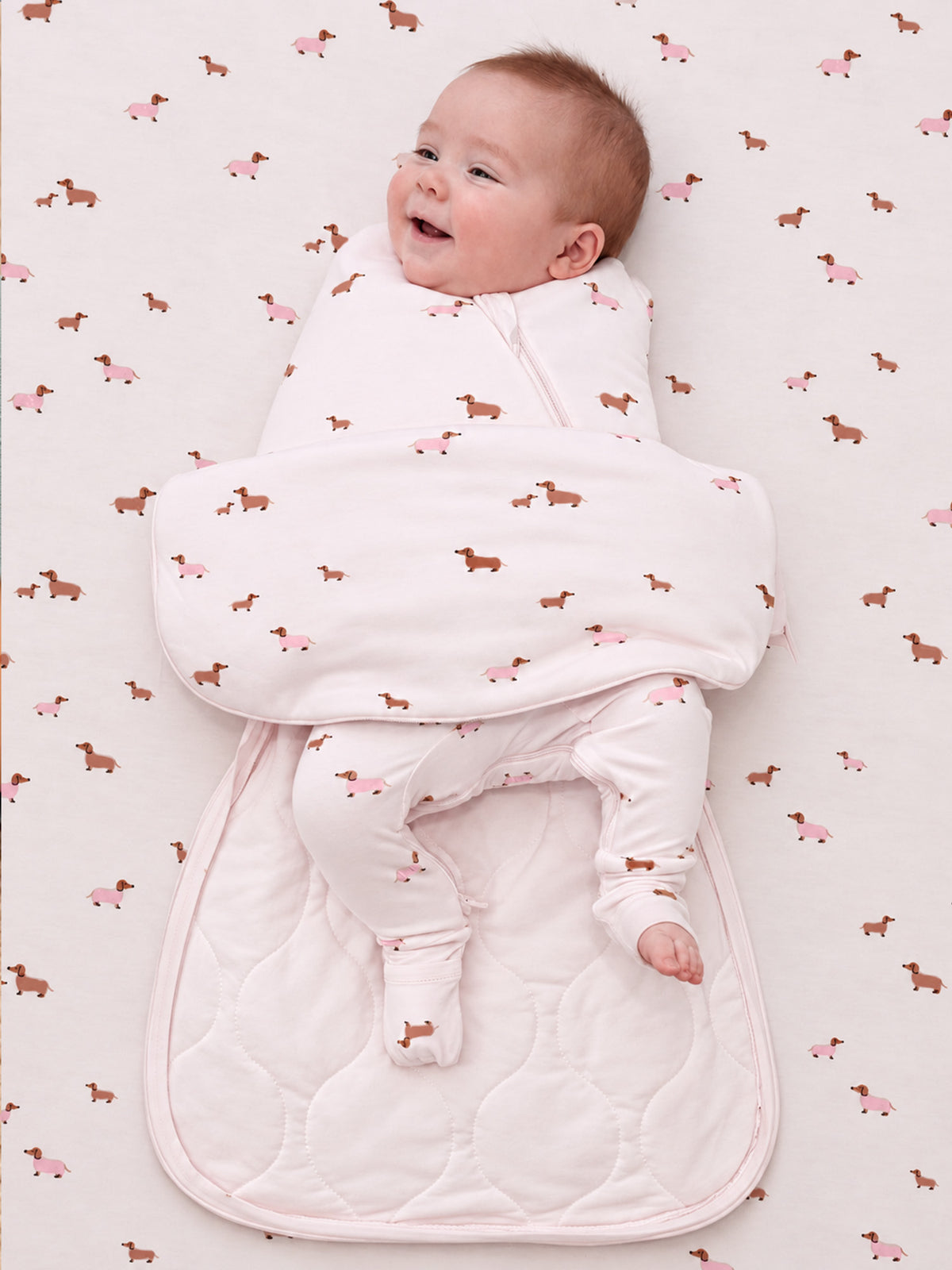 Dog-pattern swaddle sleep sack with long sleeves and padded bottom, pink zipper