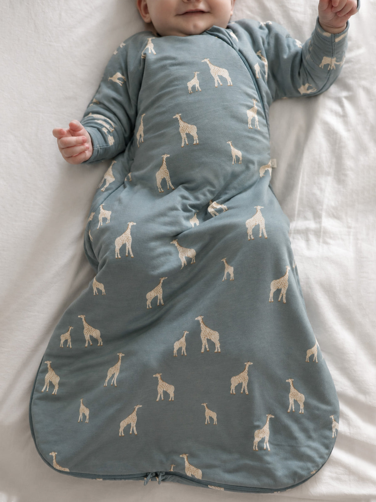 Baby swaddle sleep sack in moss green with beige giraffes and front zipper