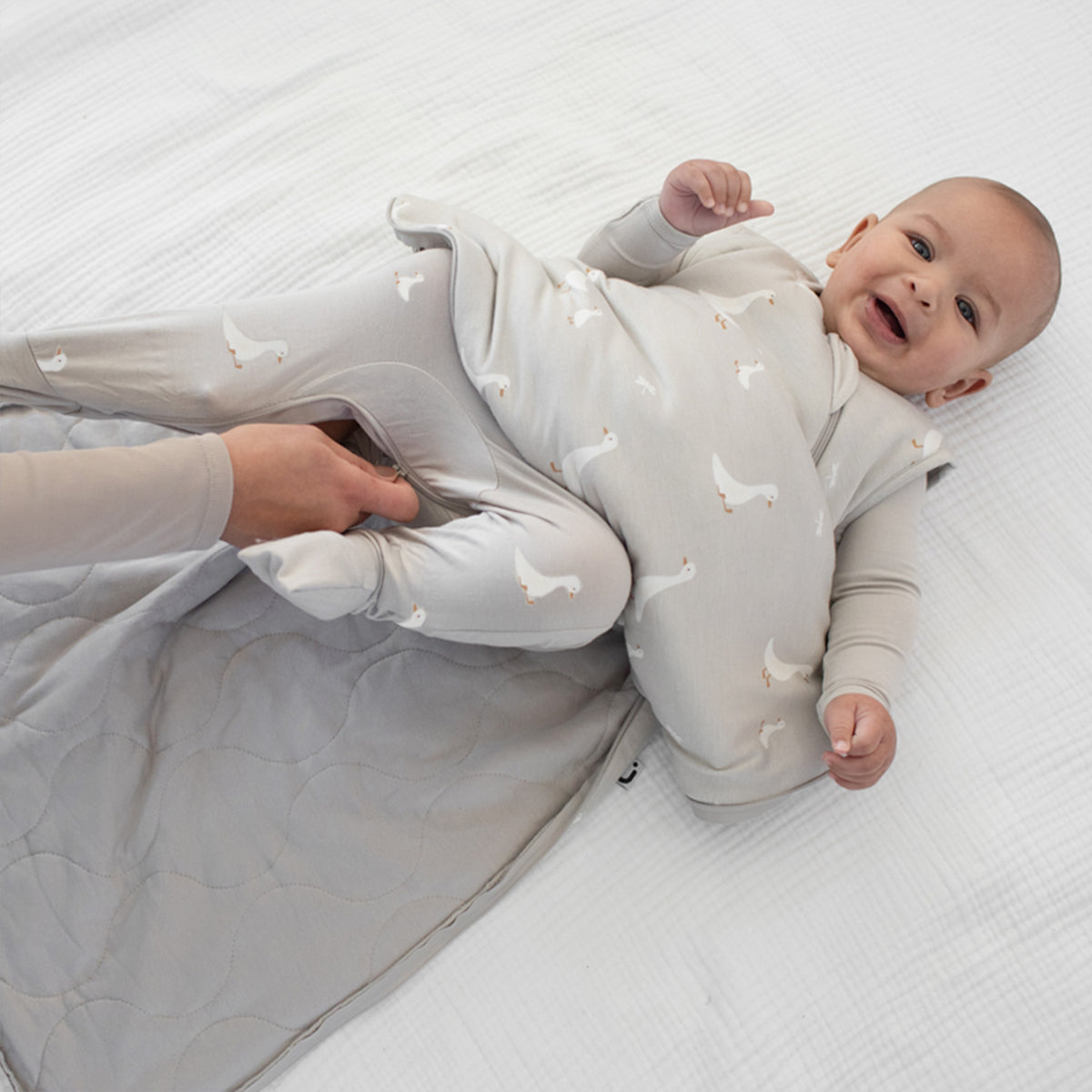 1.0 TOG goose print sleep sack, light gray; baby on back with legs out