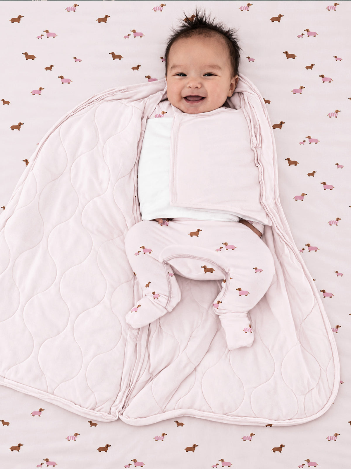Quilted dog-print sleep sack swaddle with pink zipper and roomy padded bottom