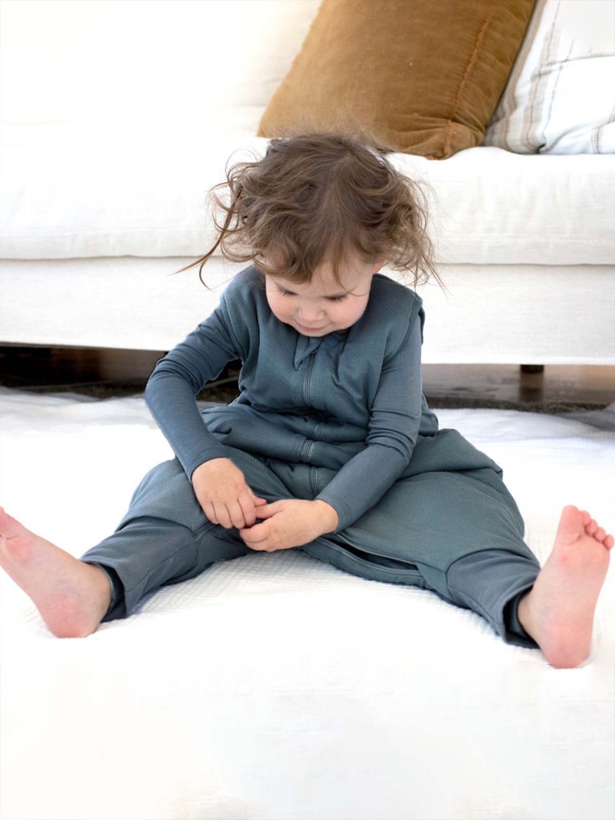Long-sleeve footed sleep sack in teal blue, full-length legs