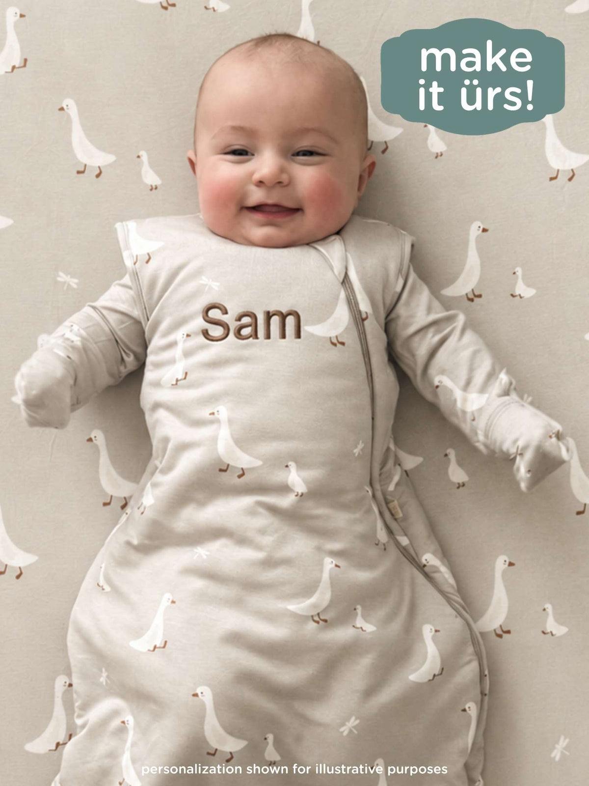 Goose print swaddle sleep sack with front name patch, cream-colored baby sleep suit