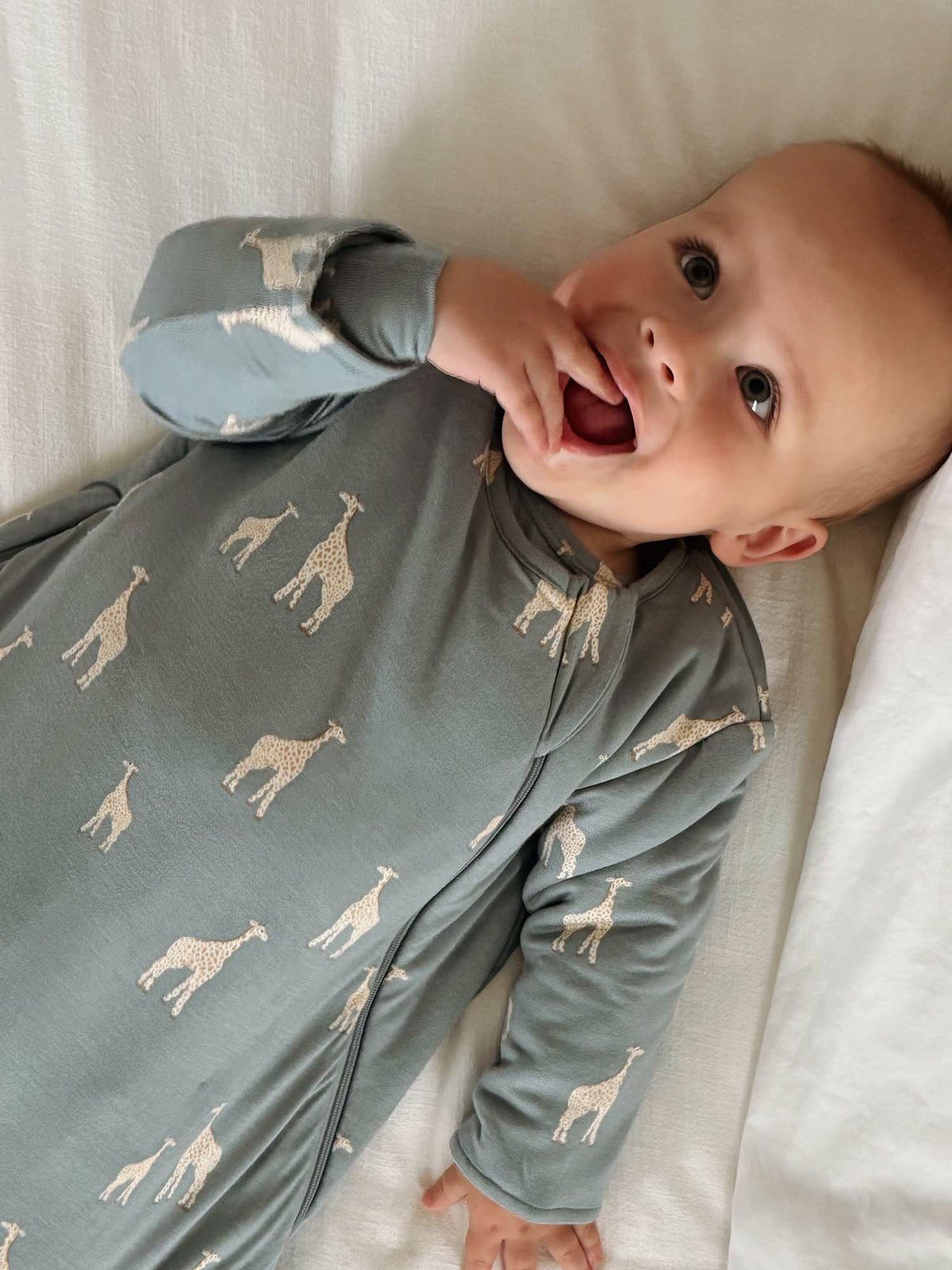 Long-sleeve sleep sack in moss green with giraffe print, zip front and cuffed sleeves