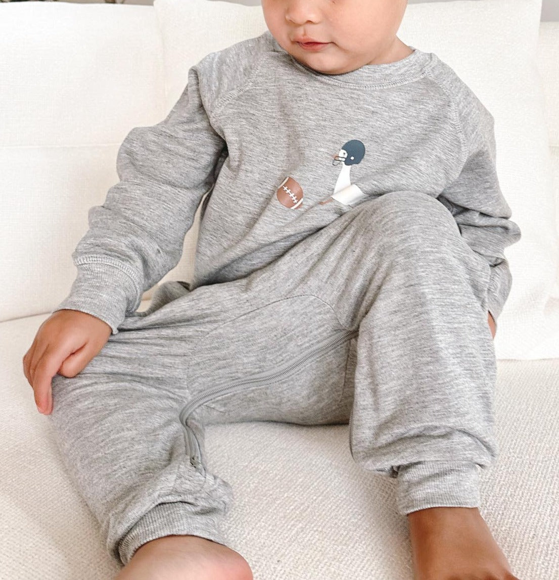 Gray fleece one-piece with goose-and-ball applique, long sleeves, and cuffed legs.