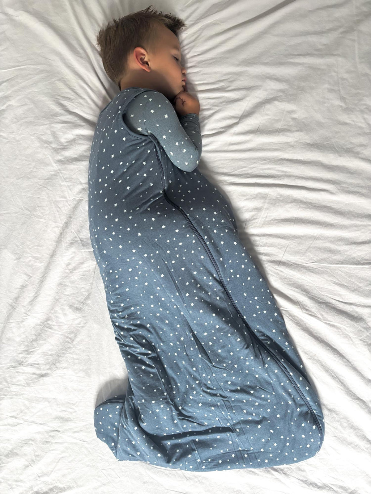 Blue 2.5 TOG sleep sack with white star print and long sleeves, zipper closure