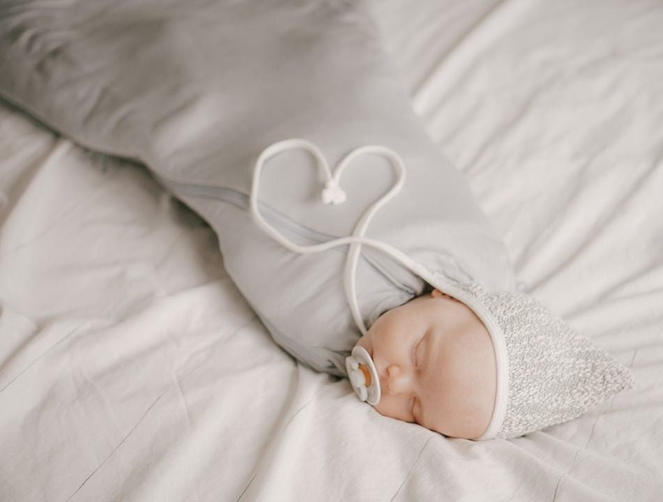 peaceful sleeping infant wrapped in a gunamuna swaddle sleep bag