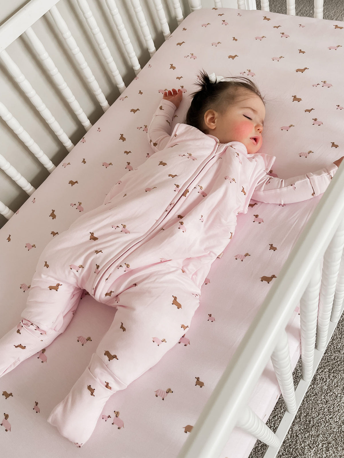 Pink dog-print footie sleep sack with full zipper and long sleeves