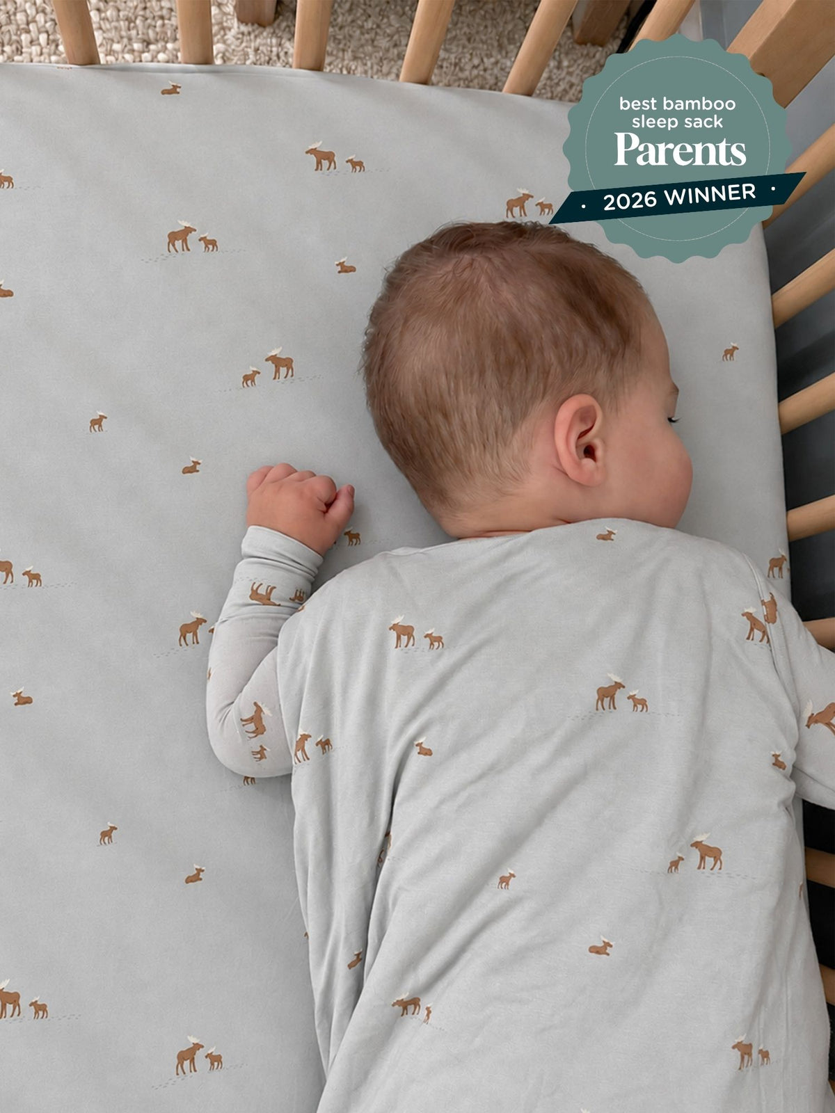 Gray moose-printed sleep sack with folded cuffs, worn by baby, 2.5 TOG