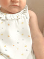 Cream duck-print sleeveless romper with ruffled collar