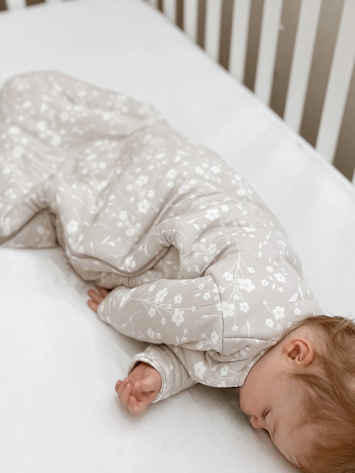 Baby sleep sack with light beige floral print, long sleeves