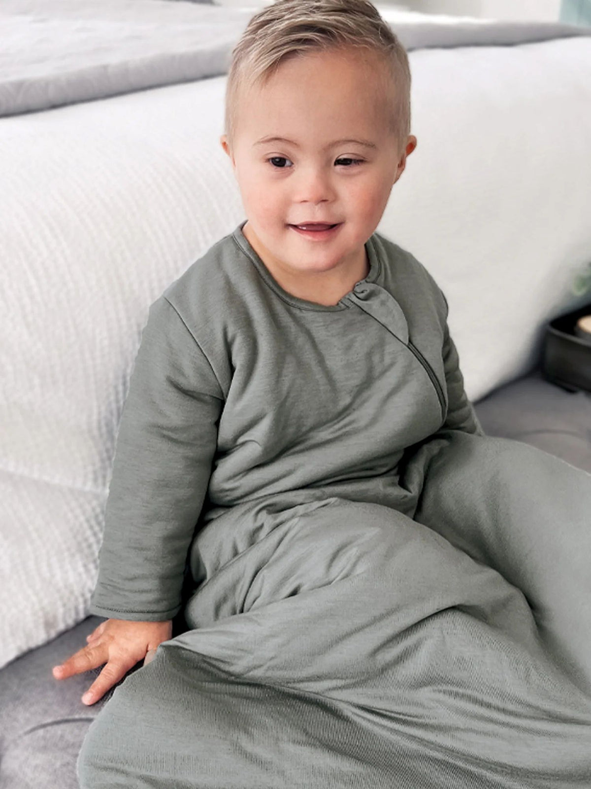 Sage green long-sleeve sleep sack with zip front and footed legs