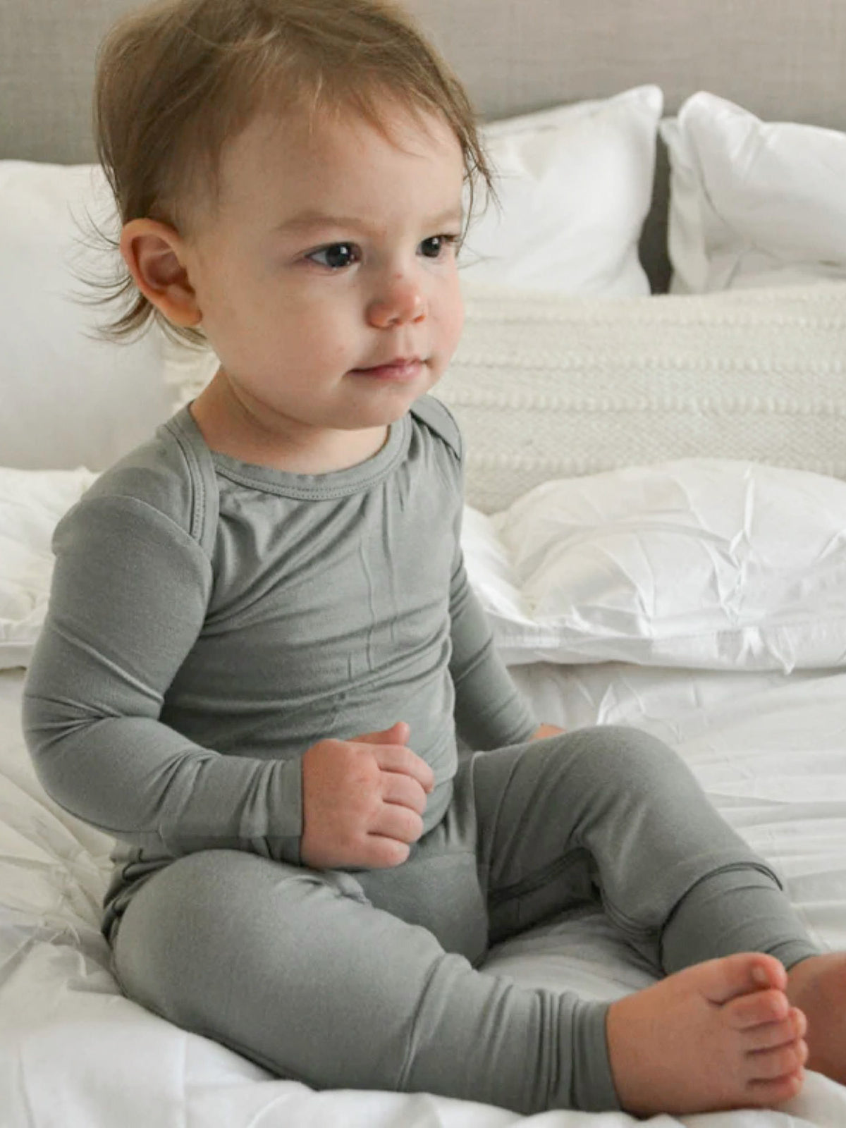 Sage green convertible pajama romper with snug fit and enclosed foot cuffs