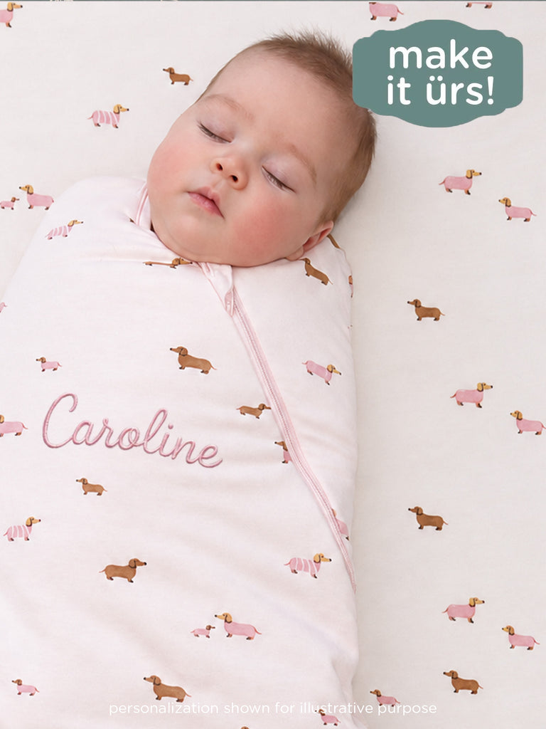 Dog-print swaddle sleep sack with pink front zipper and soft hooded wrap for baby