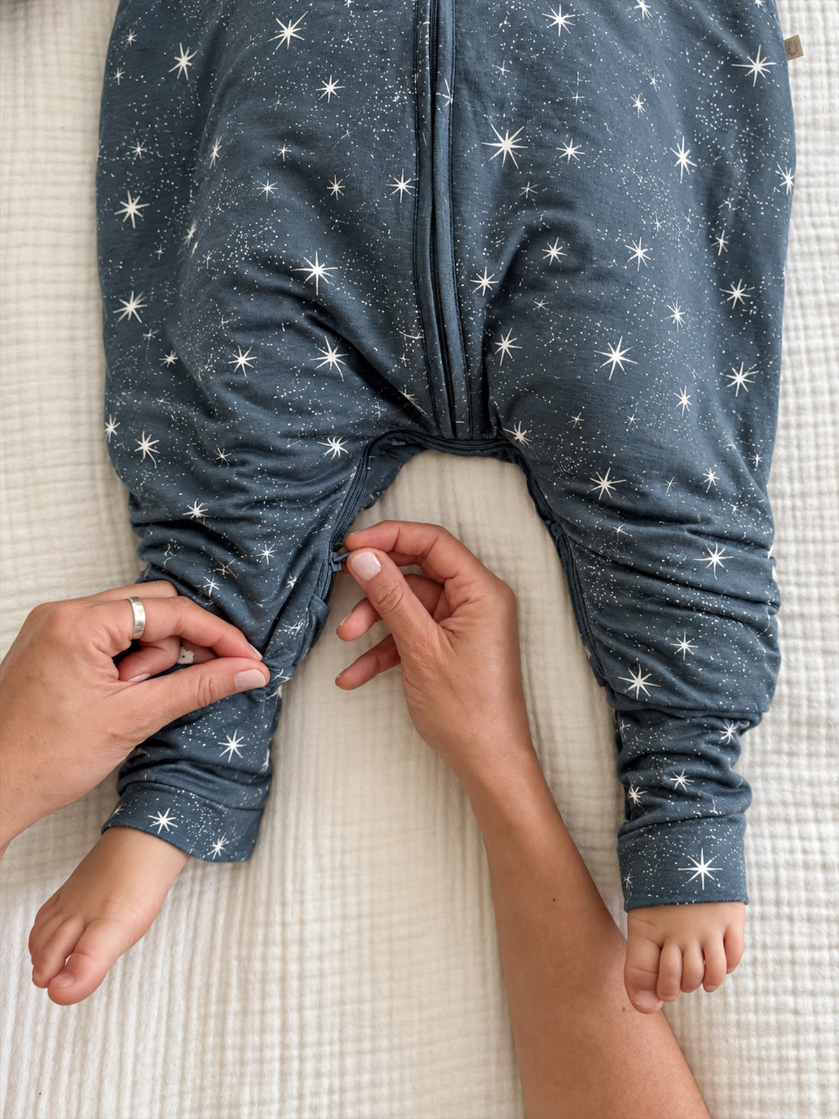 Dark blue star-print footie sleep sack with front zipper and leg cuffs