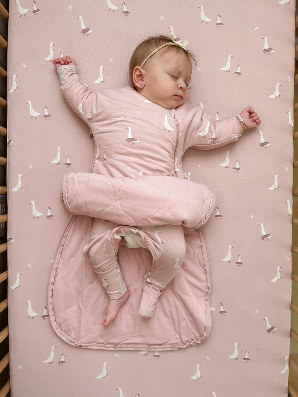 Dusty pink long-sleeve swaddle sack with goose print, open leg area