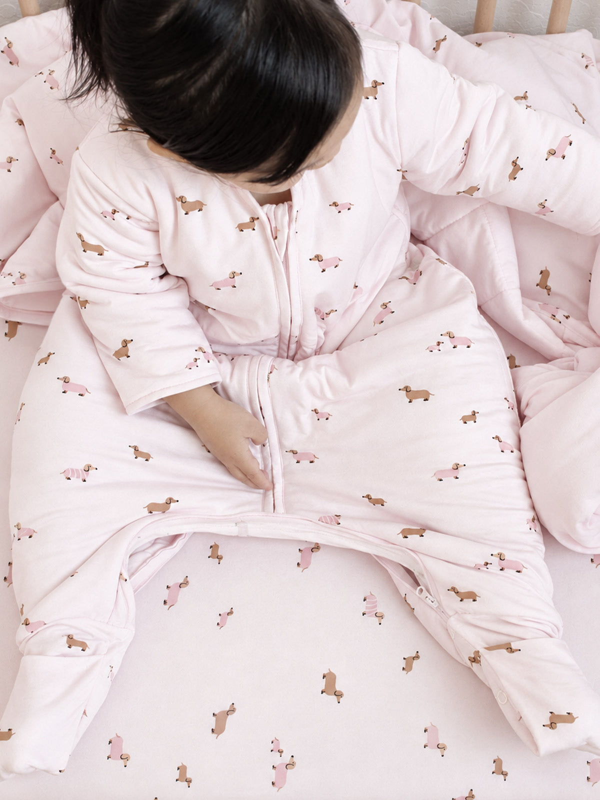 Pink dog-print footed sleep sack with long sleeves and open-zip front
