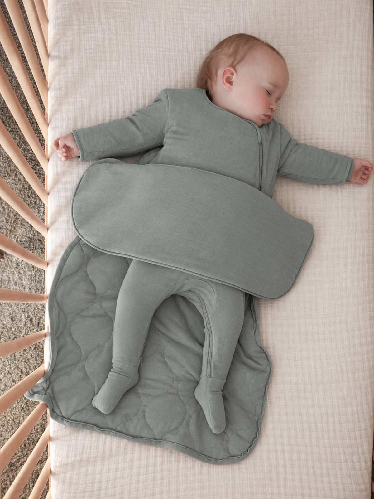Sage green long-sleeve sleep sack with front zipper, laid flat