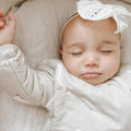 Goose-print long sleeve sleep sack on sleeping baby with front zipper detail