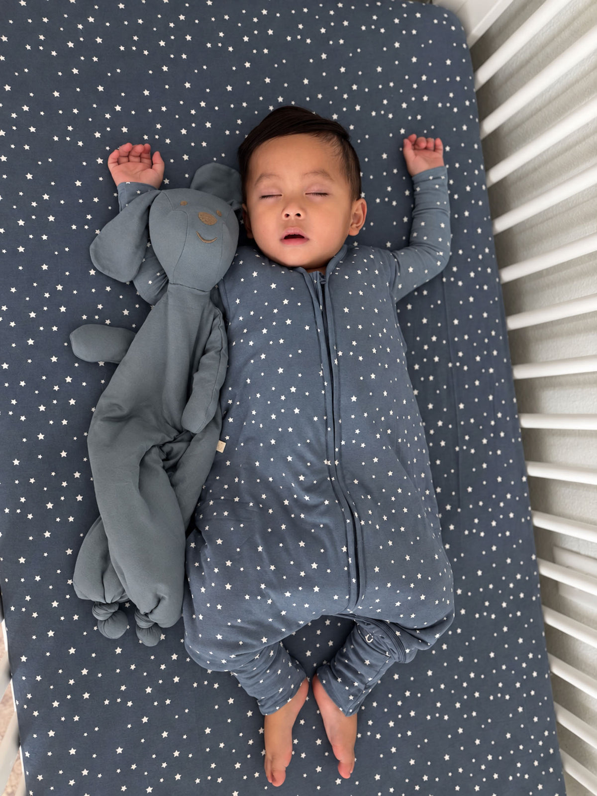 Dark gray star-pattern footie sleep sack with full front zipper and fold-over mitts