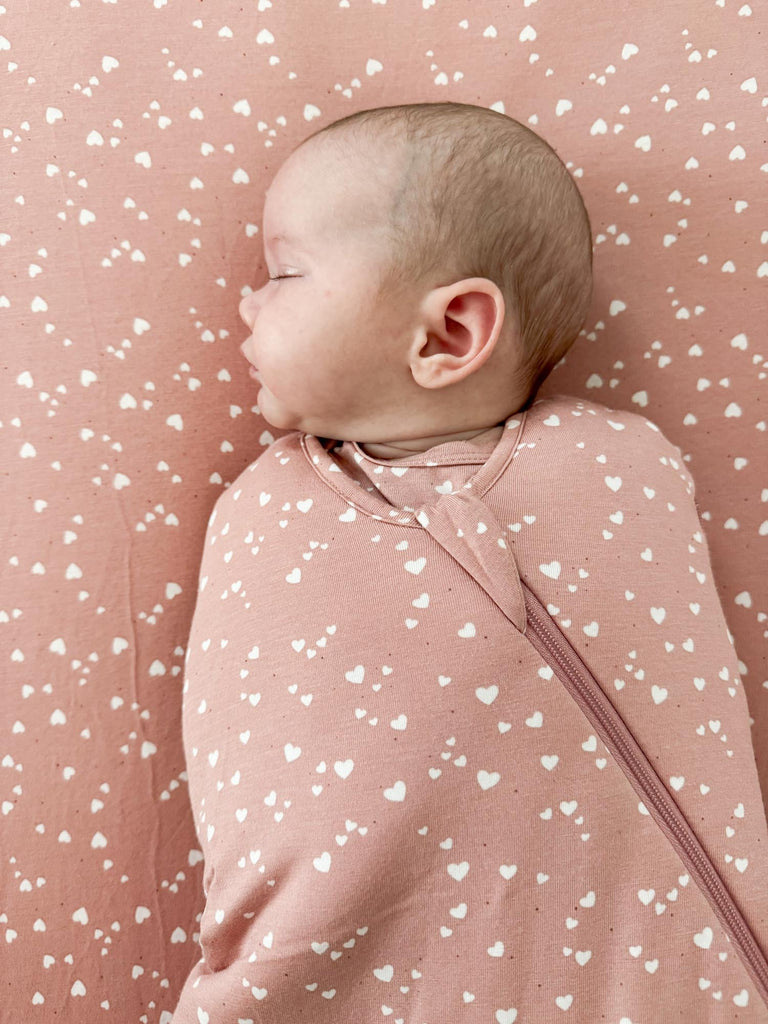 Pink 2.5 tog swaddle sleep sack with white heart print, swaddle wings
