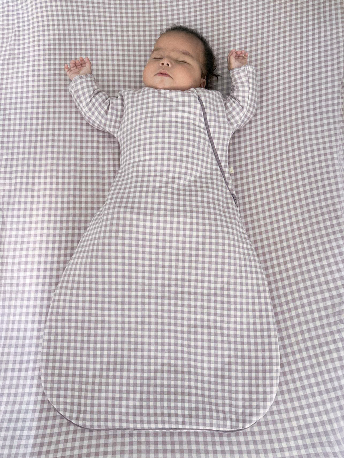Long-sleeve check swaddle sack with open bottom, baby arms in sleeves