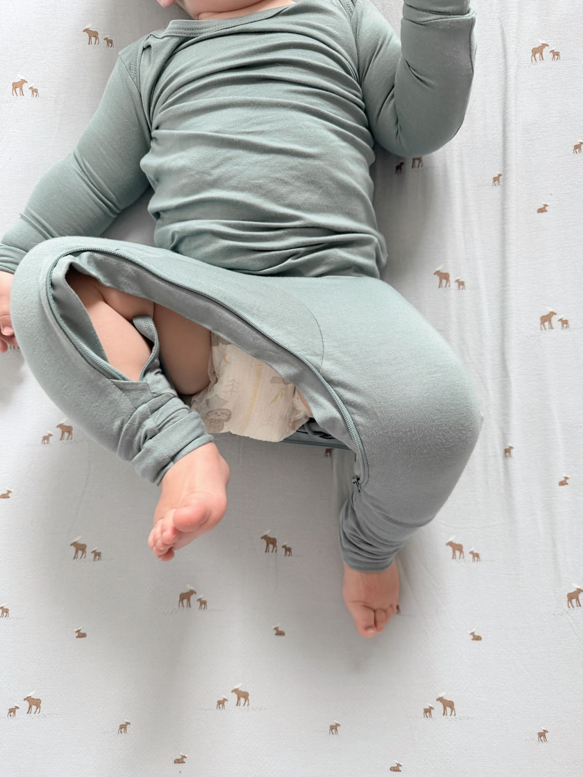 Light blue-green convertible pajamas with long sleeves, baby wearing in reclined pose