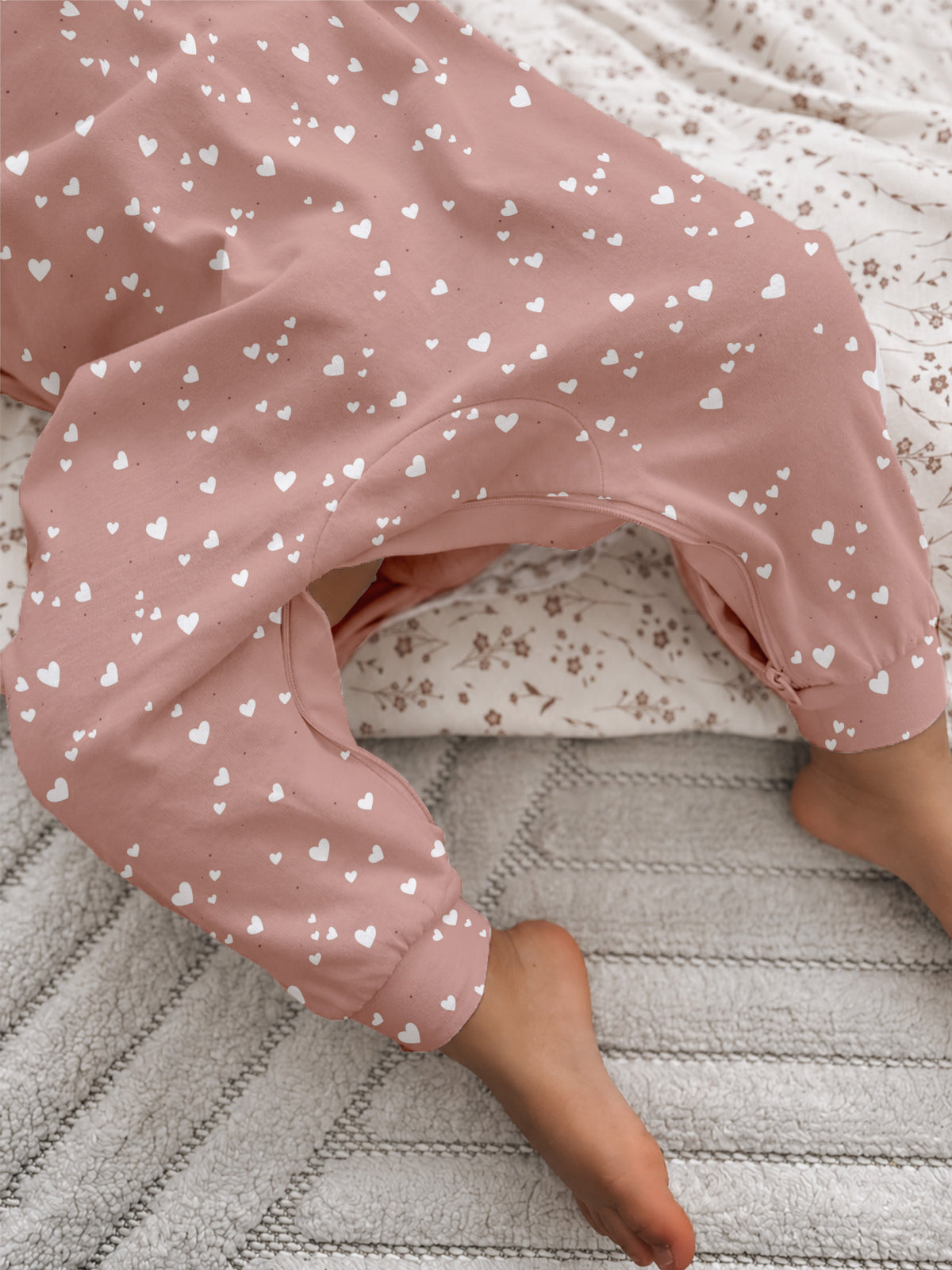 Pink heart-print fleece jumpsuit with elastic cuff and soft inner lining