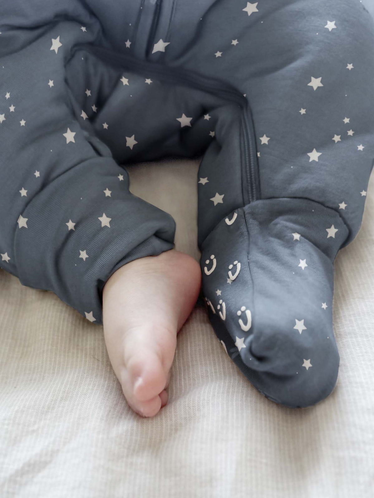 Dark blue star footie sleep sack with enclosed feet and long sleeves, full-zip