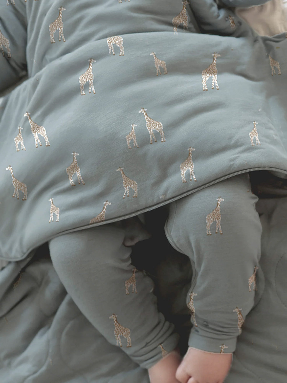 Moss green long-sleeve sleep sack with giraffe print, zip front and curved hem