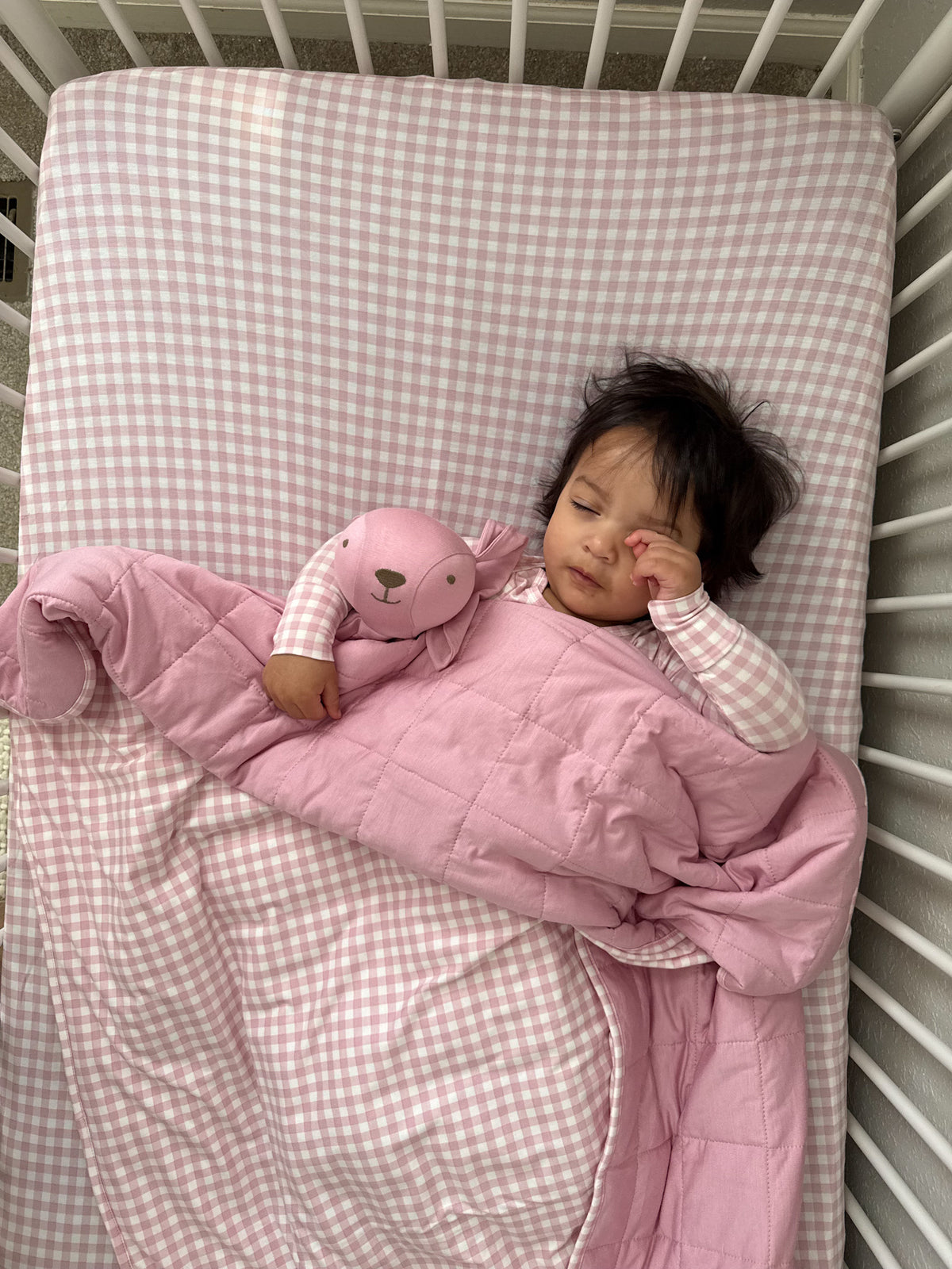 Pink padded security blanket with attached bunny plush, long ears and stitched nose