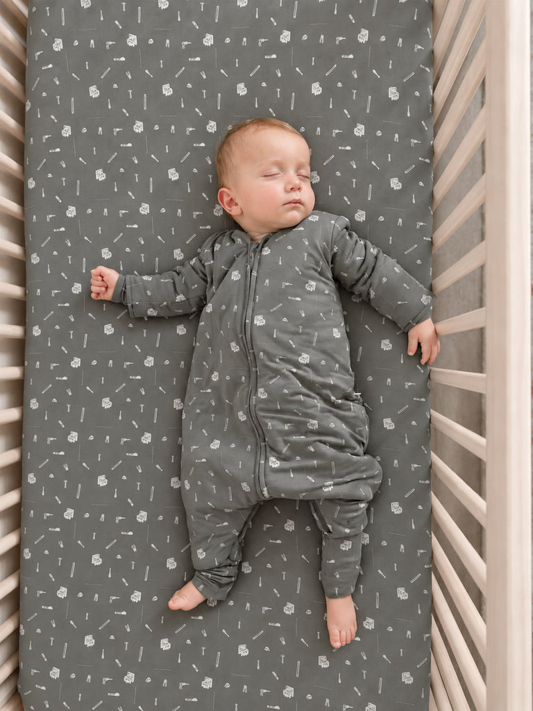 Gray long-sleeve footed sleep sack with white tool icons