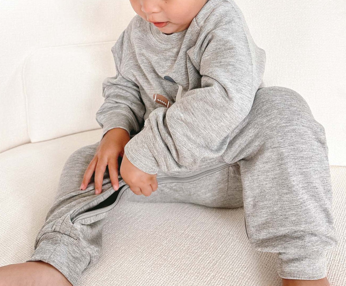 Gray fleece jumpsuit with goose applique and cuffed sleeves and legs.