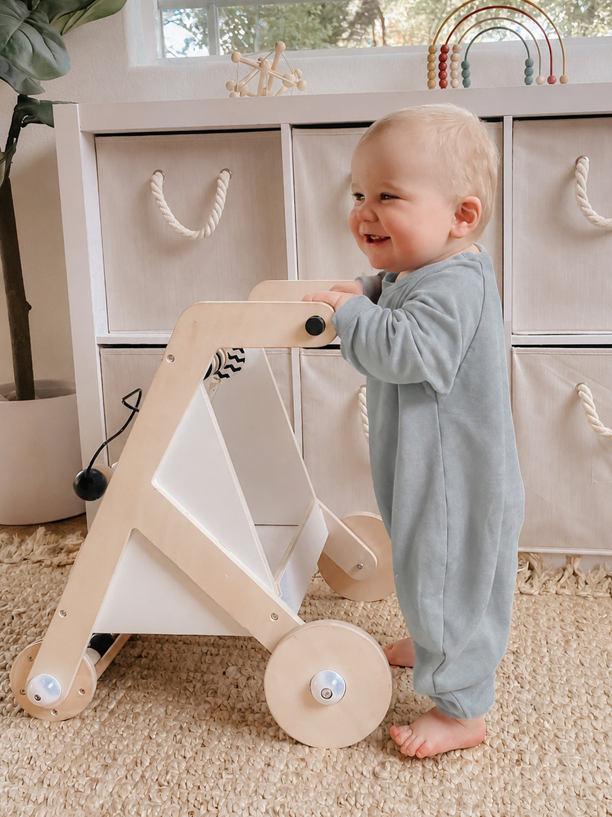 Light gray fleece jumpsuit with moose graphic, long sleeves and snap legs, baby standing